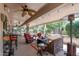 Spacious covered patio with lounge seating and an outdoor fan at 15797 W Cinnabar Dr, Surprise, AZ 85374