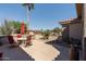 This beautiful patio includes a dining table with umbrella, desert landscaping, and a well-maintained exterior at 15797 W Cinnabar Dr, Surprise, AZ 85374