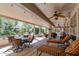 Expansive covered patio featuring lounge chairs, a dining set, and lush greenery, providing the ultimate outdoor living experience at 15797 W Cinnabar Dr, Surprise, AZ 85374