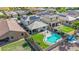 Aerial view of a home featuring solar panels, backyard pool, artificial turf, and covered patio in a desirable community at 15812 W Lisbon Ln, Surprise, AZ 85379