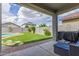 Inviting backyard oasis with artificial turf, patio, and pool is perfect for relaxing and entertaining in the backyard at 15812 W Lisbon Ln, Surprise, AZ 85379