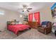 Bright, cheerful bedroom with a ceiling fan, shelving and natural light at 15812 W Lisbon Ln, Surprise, AZ 85379