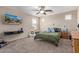 Comfortable bedroom with natural light, television, and a ceiling fan at 15812 W Lisbon Ln, Surprise, AZ 85379