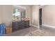 Entryway with a decorative chest of drawers under a window and dark paneled door at 15812 W Lisbon Ln, Surprise, AZ 85379