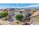 Stunning home exterior showcasing solar panels, two-car garage, and a well-maintained lawn in a beautiful neighborhood at 15812 W Lisbon Ln, Surprise, AZ 85379