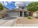 Charming two-story home featuring desert landscaping, solar panels, a two-car garage and a brick walkway at 15812 W Lisbon Ln, Surprise, AZ 85379
