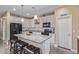 Kitchen featuring a large island with granite countertops and modern appliances at 15812 W Lisbon Ln, Surprise, AZ 85379