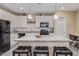 Kitchen featuring a large island with granite countertops and white cabinetry at 15812 W Lisbon Ln, Surprise, AZ 85379