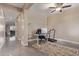 Office space with a desk, office chair, and treadmill under a ceiling fan with drop lighting at 15812 W Lisbon Ln, Surprise, AZ 85379