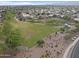 An aerial view of the neighborhood with open green spaces, walking paths, and a playground at 16235 W Cottonwood St, Surprise, AZ 85374