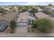 Aerial view of a well maintained home with desert landscaping and solar panels on the roof at 16235 W Cottonwood St, Surprise, AZ 85374