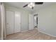Bedroom with wood-look floors, neutral paint, and access to an en-suite bathroom at 16235 W Cottonwood St, Surprise, AZ 85374