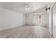Large bedroom with vaulted ceiling, ceiling fan, light walls, tile floors, and large window with curtains at 16235 W Cottonwood St, Surprise, AZ 85374