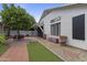 Back exterior with artificial grass, pavers, gravel, and decorative potted plants at 16235 W Cottonwood St, Surprise, AZ 85374
