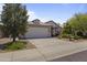 Charming single-story home featuring a tile roof, a two-car garage, and well-maintained desert landscaping at 16235 W Cottonwood St, Surprise, AZ 85374