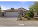 Charming single-story home featuring a tile roof, a two-car garage, and well-maintained desert landscaping at 16235 W Cottonwood St, Surprise, AZ 85374