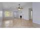 Bright and spacious living room with tile flooring, a decorative fireplace, and large windows at 16235 W Cottonwood St, Surprise, AZ 85374