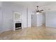 Bright living room with tiled floors, a decorative fireplace, and a modern ceiling fan at 16235 W Cottonwood St, Surprise, AZ 85374