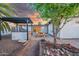 Backyard patio with an outdoor kitchen, dining area, and desert-friendly landscaping at 1644 W Roma Ave, Phoenix, AZ 85015