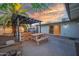Outdoor kitchen with stone detail and a picnic table set in a cozy backyard at 1644 W Roma Ave, Phoenix, AZ 85015