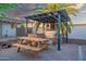 Backyard patio featuring an outdoor kitchen with a picnic table for outdoor dining at 1644 W Roma Ave, Phoenix, AZ 85015