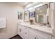 Bright bathroom features double vanity with modern fixtures, granite counters and updated lighting at 1644 W Roma Ave, Phoenix, AZ 85015