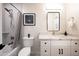 Bathroom features shower over tub, vanity with granite counters and storage, and black framed mirror at 1644 W Roma Ave, Phoenix, AZ 85015