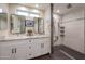 Bright bathroom features a double sink vanity with granite counters and a walk-in shower at 1644 W Roma Ave, Phoenix, AZ 85015