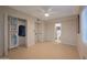 Bedroom features tile flooring, a ceiling fan and a closet with built-in organizers at 1644 W Roma Ave, Phoenix, AZ 85015
