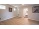 Bright bedroom with lots of natural light, features light colored walls, light wood floors and ensuite bathroom at 1644 W Roma Ave, Phoenix, AZ 85015