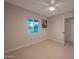 Bedroom features tile flooring, a ceiling fan and a window at 1644 W Roma Ave, Phoenix, AZ 85015