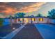 Inviting single-story home with a well-lit walkway and chairs adding to the curb appeal at 1644 W Roma Ave, Phoenix, AZ 85015