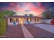Charming single-story home featuring manicured front yard, walkway, and colorful sky at dusk at 1644 W Roma Ave, Phoenix, AZ 85015