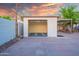 A detached, white garage with an open door, and a concrete driveway leading up to it in the backyard at 1644 W Roma Ave, Phoenix, AZ 85015