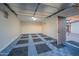 Inside the garage with an interesting gray and black pattern floor and a door on the right at 1644 W Roma Ave, Phoenix, AZ 85015