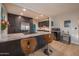 Open-concept kitchen with granite counters, bar stool seating, and stainless steel appliances at 1644 W Roma Ave, Phoenix, AZ 85015