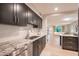 Modern kitchen featuring gray cabinetry, stainless steel appliances, and white backsplash at 1644 W Roma Ave, Phoenix, AZ 85015