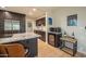 Open-concept kitchen features a stainless steel refrigerator, granite countertops, and modern appliances with a wine fridge at 1644 W Roma Ave, Phoenix, AZ 85015