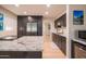 Bright kitchen features granite countertops, stainless steel appliances, and dark wood cabinets with an open design at 1644 W Roma Ave, Phoenix, AZ 85015