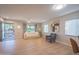 Inviting living room with a modern white sofa, a cozy armchair, and an open door to the front yard at 1644 W Roma Ave, Phoenix, AZ 85015