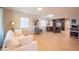 Bright living room featuring a white sofa, stylish armchair, and an open view into the kitchen area at 1644 W Roma Ave, Phoenix, AZ 85015