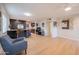 Open-concept living room and kitchen area with wood floors and modern appliances at 1644 W Roma Ave, Phoenix, AZ 85015