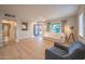 Spacious living room with stylish decor, featuring a comfortable white sofa and an open view of the entry at 1644 W Roma Ave, Phoenix, AZ 85015