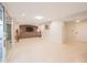 Bright recreation room with stone accent wall, built-in cabinets, and sliding glass door at 1644 W Roma Ave, Phoenix, AZ 85015