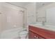A clean bathroom with bathtub, toilet, tile flooring, and a dark wood vanity at 17 W Vernon Ave # 121, Phoenix, AZ 85003