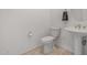 Classic bathroom featuring a toilet and pedestal sink with tiled flooring at 17 W Vernon Ave # 121, Phoenix, AZ 85003