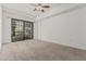 Spacious bedroom with neutral carpet and sliding glass door to balcony at 17 W Vernon Ave # 121, Phoenix, AZ 85003