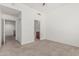 Bedroom view with neutral carpet, open closet, and an ensuite bathroom in a well-lit space at 17 W Vernon Ave # 121, Phoenix, AZ 85003