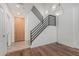 Bright entryway showcasing modern staircase, wood floors, and stylish lighting fixtures at 17 W Vernon Ave # 121, Phoenix, AZ 85003