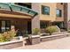 Charming brick building entrance with a covered seating area and manicured landscaping at 17 W Vernon Ave # 121, Phoenix, AZ 85003